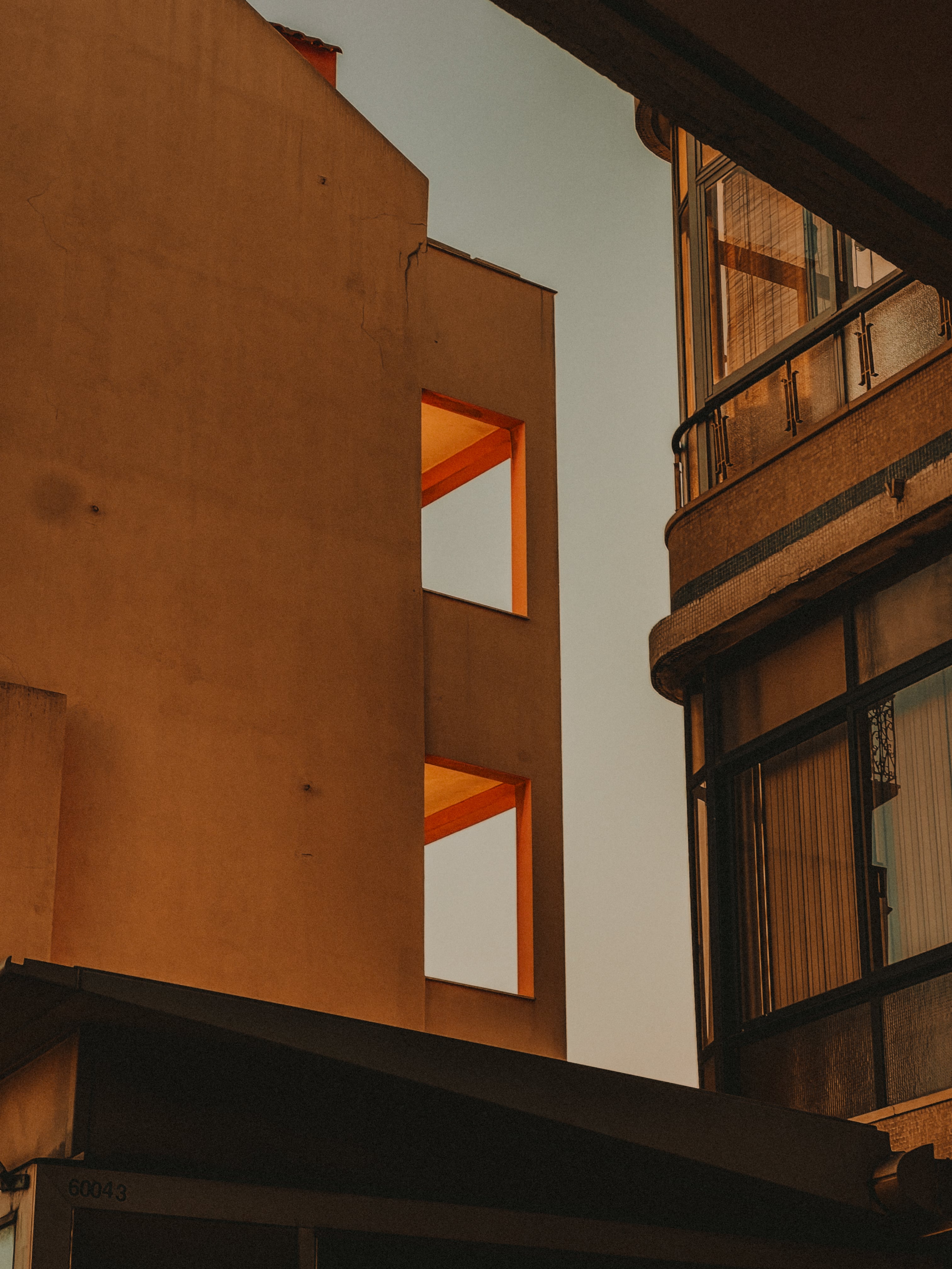 Orange light through building window openings, architectural detail — Graça, Lisbon