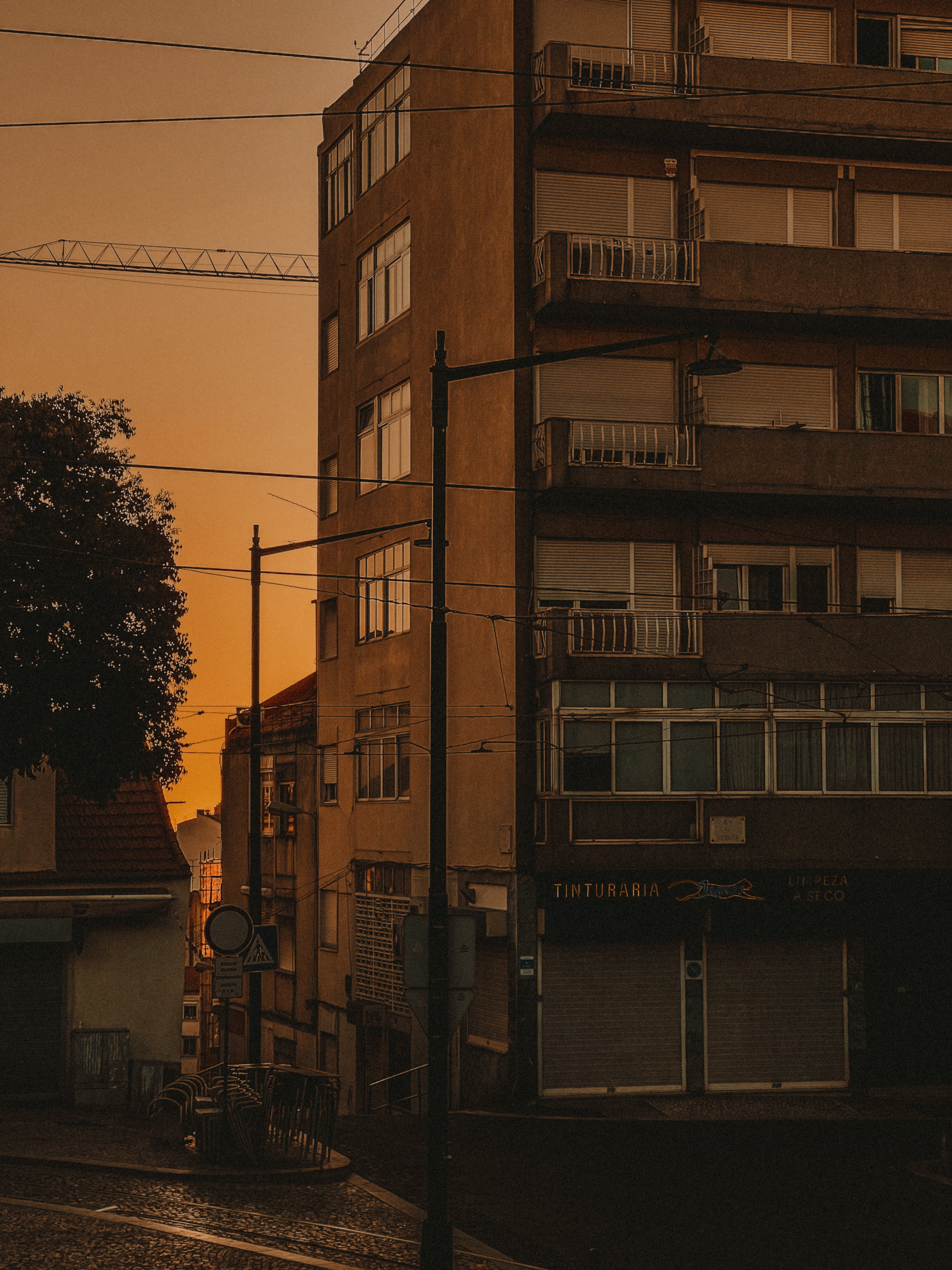 Tinturaria dry cleaner corner building at deep sunset — Rua da Graça, Lisbon