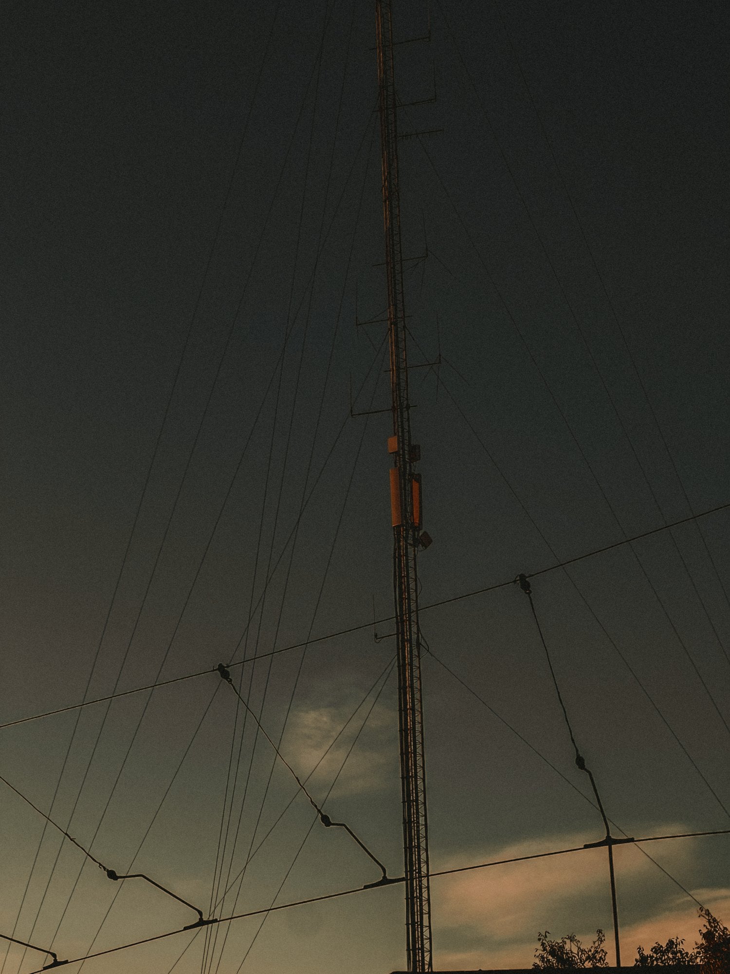 Looking straight up at tram wire pole, almost industrial — Graça, Lisbon
